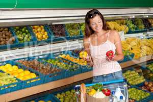 Grocery store shopping - Woman holding two peppers