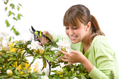 Gardening - woman cutting flower with pruning shears