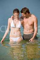 Couple in swimwear enjoy water and sun in summer