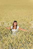 Happy young woman in corn field enjoy sunset