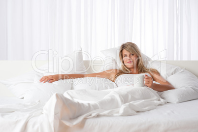 White lounge - Blond woman with cup of coffee