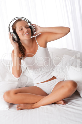 Young woman in white with headphones