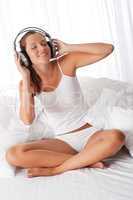 Young woman in white with headphones