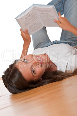 Brown hair teenager lying down on wooden floor