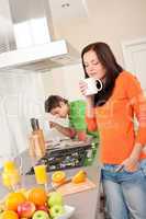 Young woman having coffee in the kitchen