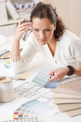 Young female interior designer working at office