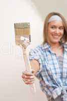 Home improvement: Young woman with paint brush
