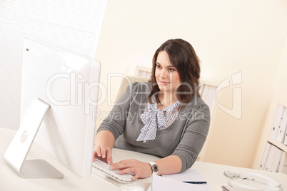 Young attractive business woman working at office