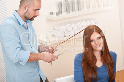 Professional hairdresser cut with scissors at salon