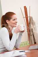 Long red hair woman at office with coffee