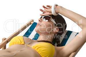 Beach - Woman with ear buds sunbathing in bikini