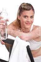 Fitness series - Woman with exercise bike  and bottle of water