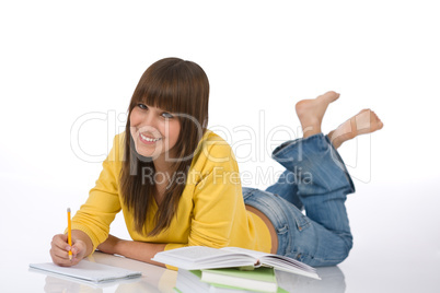 Happy female teenager write homework