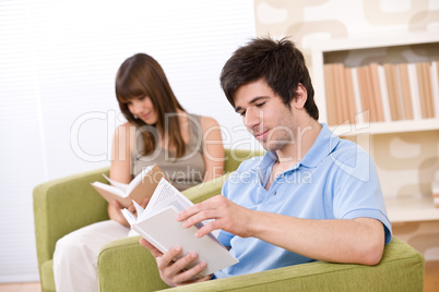 Student - two teenager reading book in lounge
