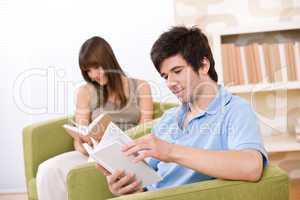 Student - two teenager reading book in lounge