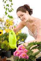 Gardening - woman with watering can and flowers