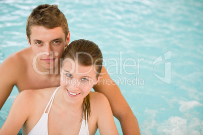 Young sportive couple relax in swimming pool