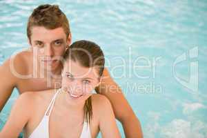 Young sportive couple relax in swimming pool