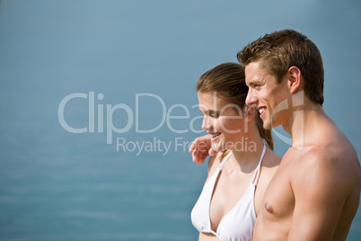 Couple in swimwear enjoy water and sun at sea