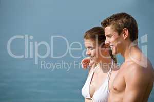 Couple in swimwear enjoy water and sun at sea
