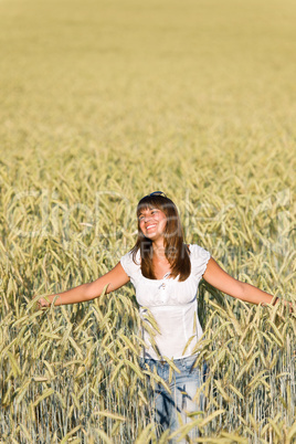 Happy young woman in corn field enjoy sunset