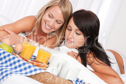 Two happy women having home made breakfast
