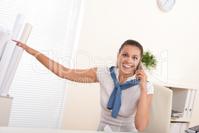 Happy female architect on the phone