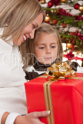 Happy blond woman with child on Christmas