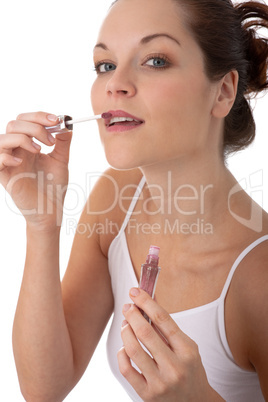 Body care series - Beautiful young woman applying lipstick