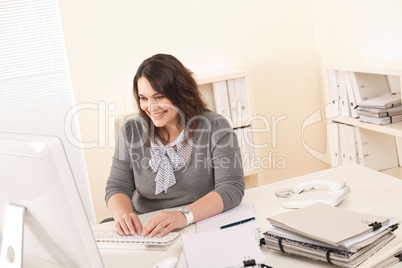 Young attractive business woman working at office