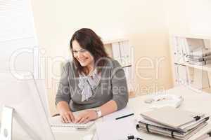 Young attractive business woman working at office