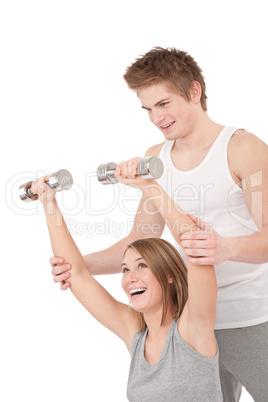 Fitness - Young woman with instructor lifting weights