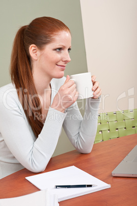 Young red hair woman at office with coffee