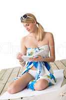 Beach - woman sitting with book, sunbathing