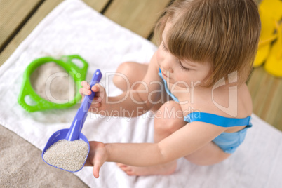 Beach - Little girl playing with beach toys