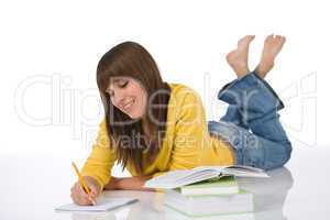 Happy female teenager write homework