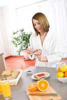 Breakfast - Happy woman with toast and marmalade