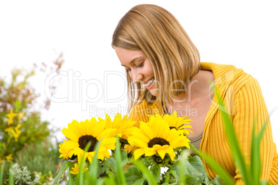 Gardening - portrait of smiling woman with sunflowers