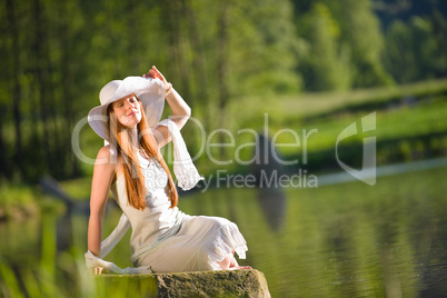 Long red hair romantic woman relax by lake