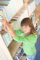 Student in library - happy woman search for book