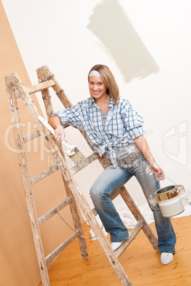 Home improvement: Smiling woman with paint and brush