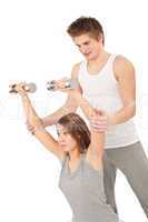 Fitness - Young woman with instructor lifting weights