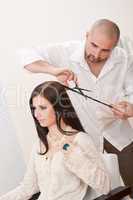 Professional hairdresser cut with scissors at salon