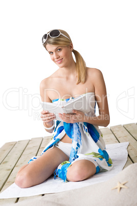 Beach - woman sitting with book, sunbathing