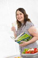 Cook - plus size happy woman holding cookbook