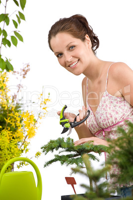 Gardening - woman cutting tree with pruning shears