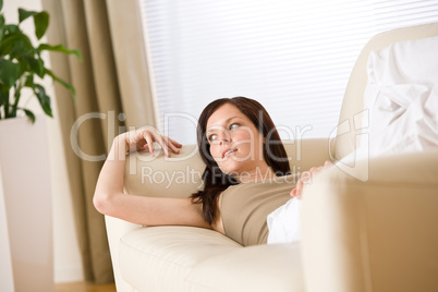 Young woman relax lying down on sofa