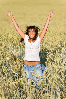 Happy woman jump in corn field in summer