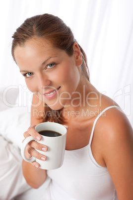 Beautiful young woman holding cup of coffee