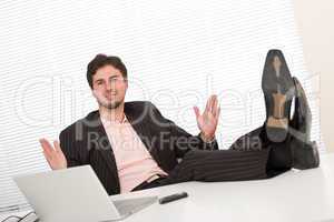 Successful businessman gesturing at office